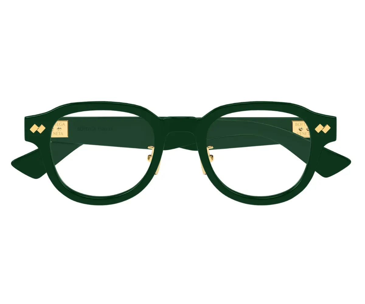 Green eyeglasses with gold accents on a white background