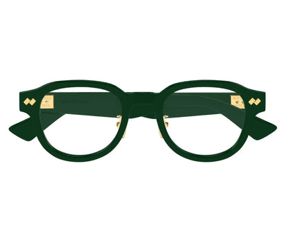 Green eyeglasses with gold accents on a white background