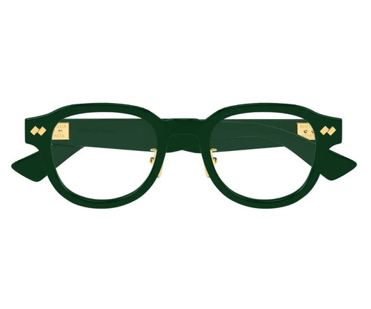 Green eyeglasses with gold accents on a white background