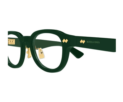 Green eyeglasses with gold accents on a white background