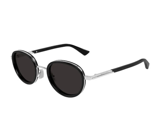 Sunglasses with silver frame and dark lenses on a white background