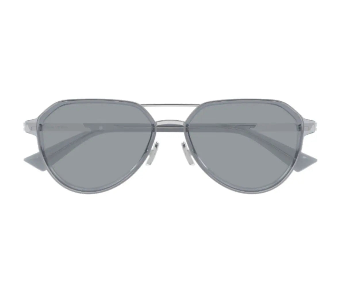 Sunglasses with a silver frame and dark lenses on a white background