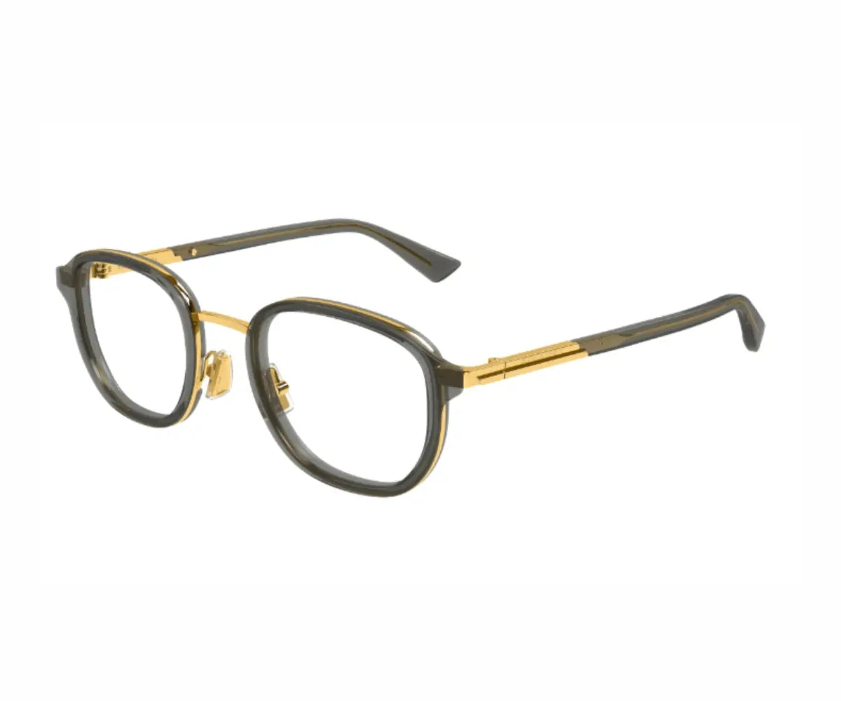 Eyeglasses with gold and black frame on a white background