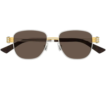 Sunglasses with gold frame and dark lenses on a white background