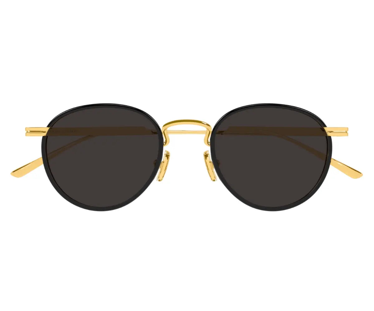 Round sunglasses with gold frame and dark lenses on a white background