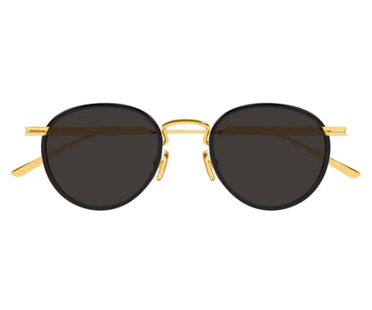 Round sunglasses with gold frame and dark lenses on a white background