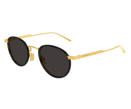 Round sunglasses with gold frame and dark lenses on a white background