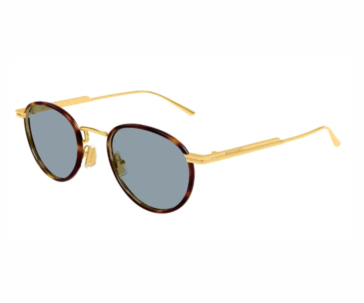 Sunglasses with gold frame and tortoiseshell lenses on a white background