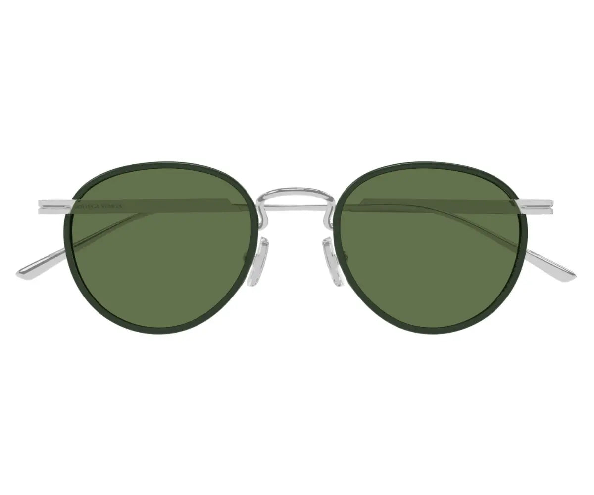 Round sunglasses with green lenses and silver frames on a white background