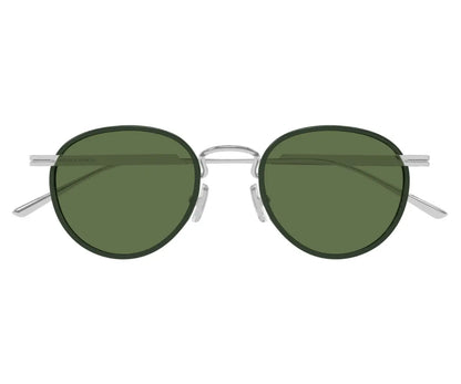 Round sunglasses with green lenses and silver frames on a white background