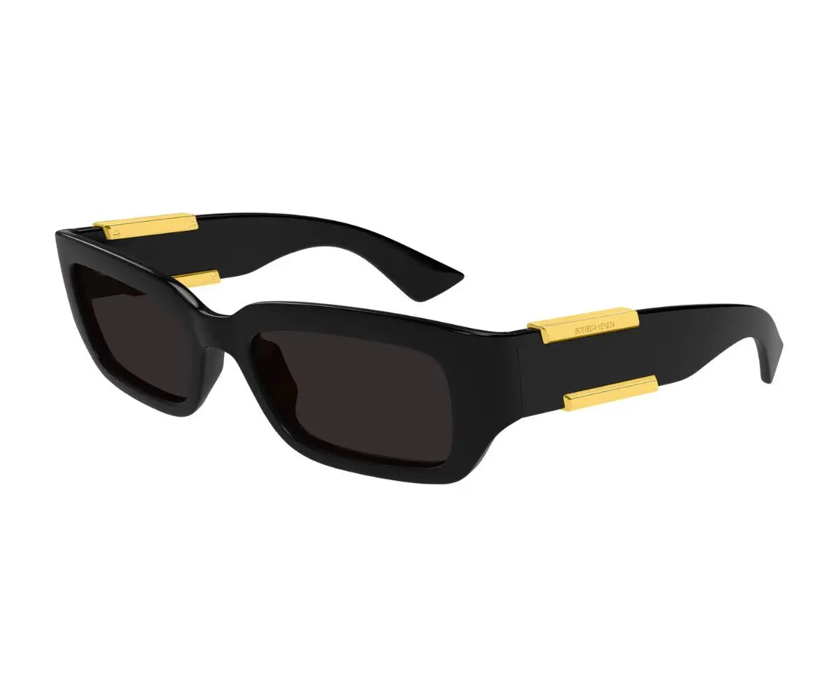 Black sunglasses with gold accents on a white background