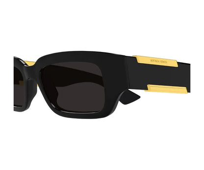 Black sunglasses with gold accents on a white background