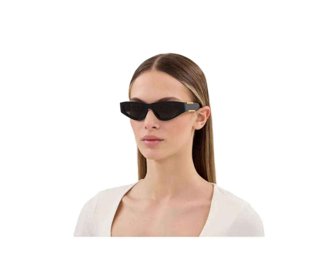 Woman wearing black sunglasses on a white background