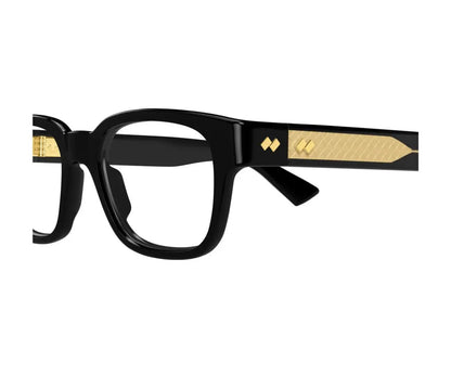 Black eyeglasses with gold accents on a white background