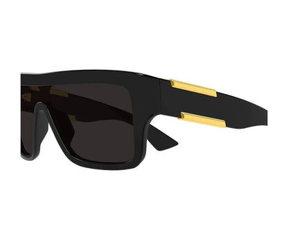 Black sunglasses with gold accents on a white background