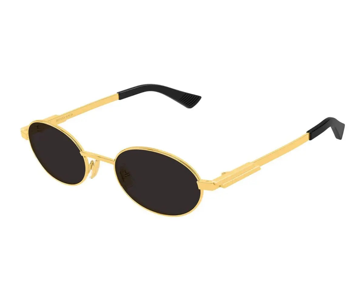 Gold-framed sunglasses with black lenses on a white background