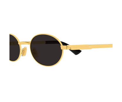 Gold-framed sunglasses with black lenses on a white background