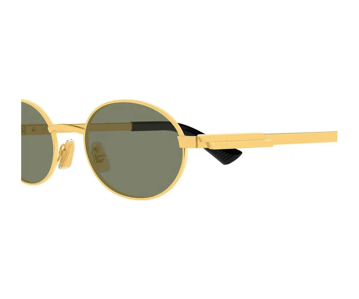 Gold-framed sunglasses with green lenses on a white background