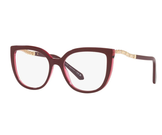 Red cat-eye glasses with gold accents on a white background