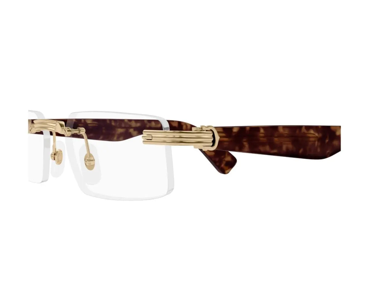 Clear face shield with gold frame and tortoiseshell band on a white background