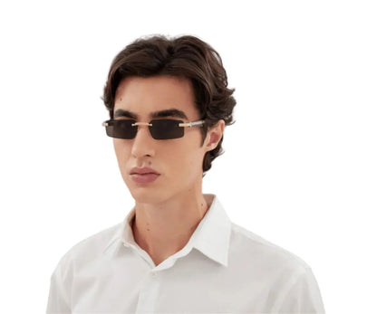 Man wearing sunglasses and a white shirt on a white background