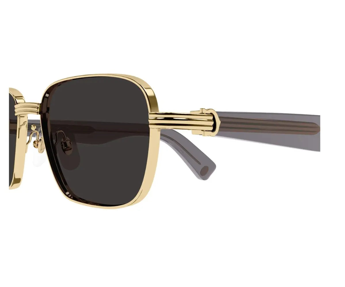 Gold-framed sunglasses with dark lenses on a white background
