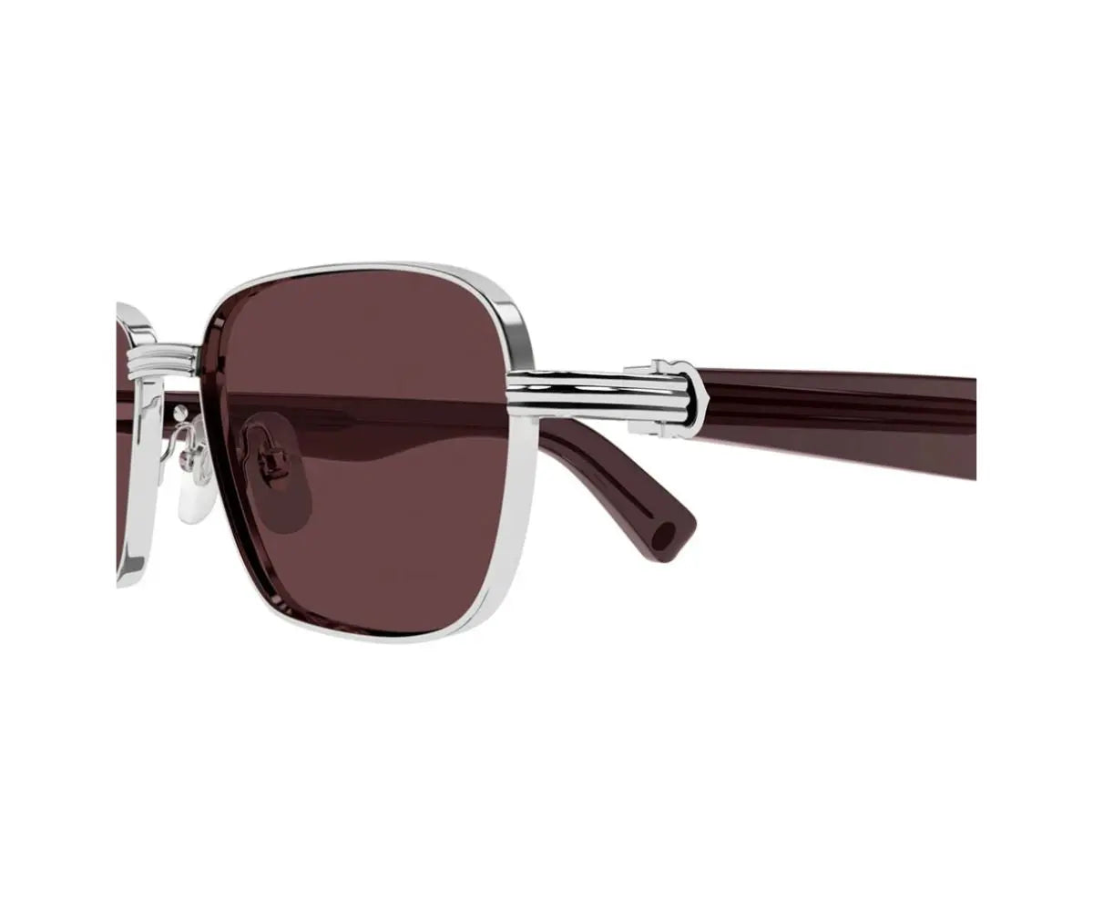 Sunglasses with brown lenses and silver frame on a white background