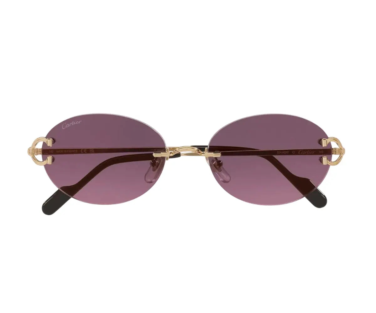 Sunglasses with gold frames and purple lenses on a white background