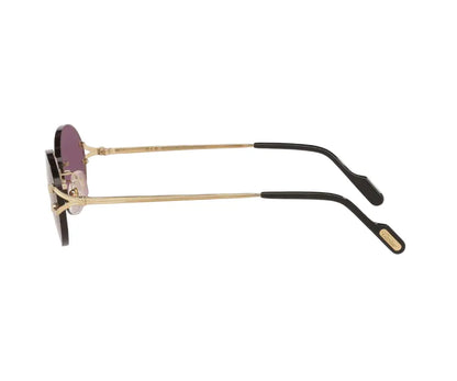 Sunglasses with gold frame and black arms on a white background