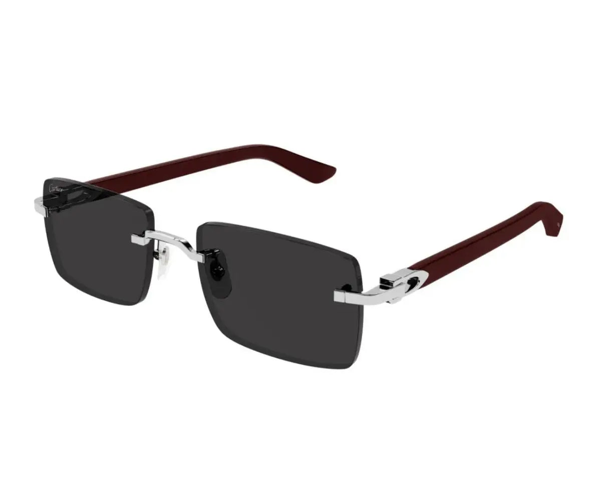 Sunglasses with dark lenses and brown and silver frame on a white background