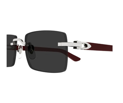 Sunglasses with a dark lens and brown and silver frame on a white background