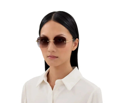 Woman wearing sunglasses with a plain white background