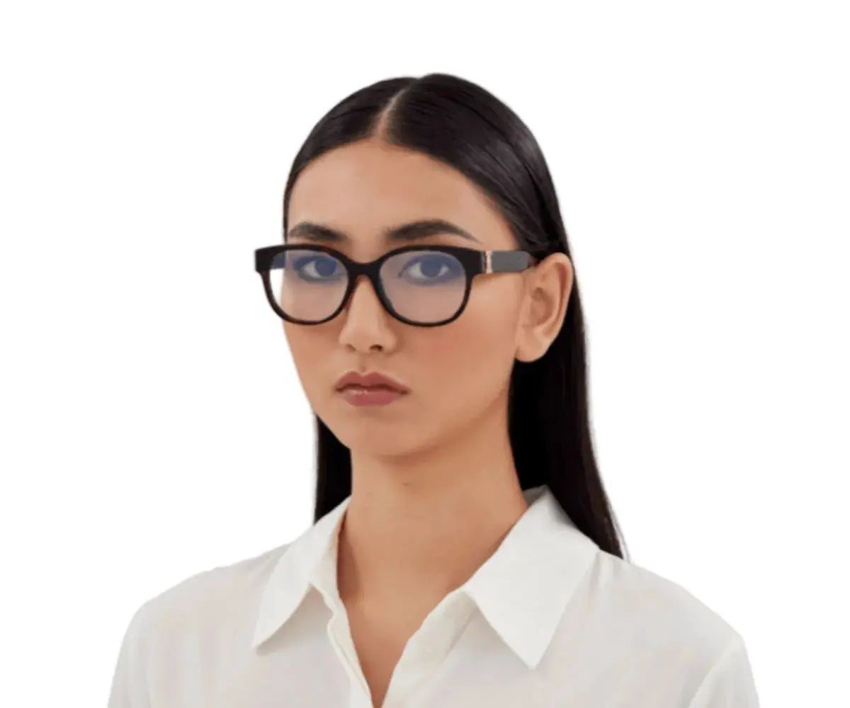 Woman wearing black glasses against a white background