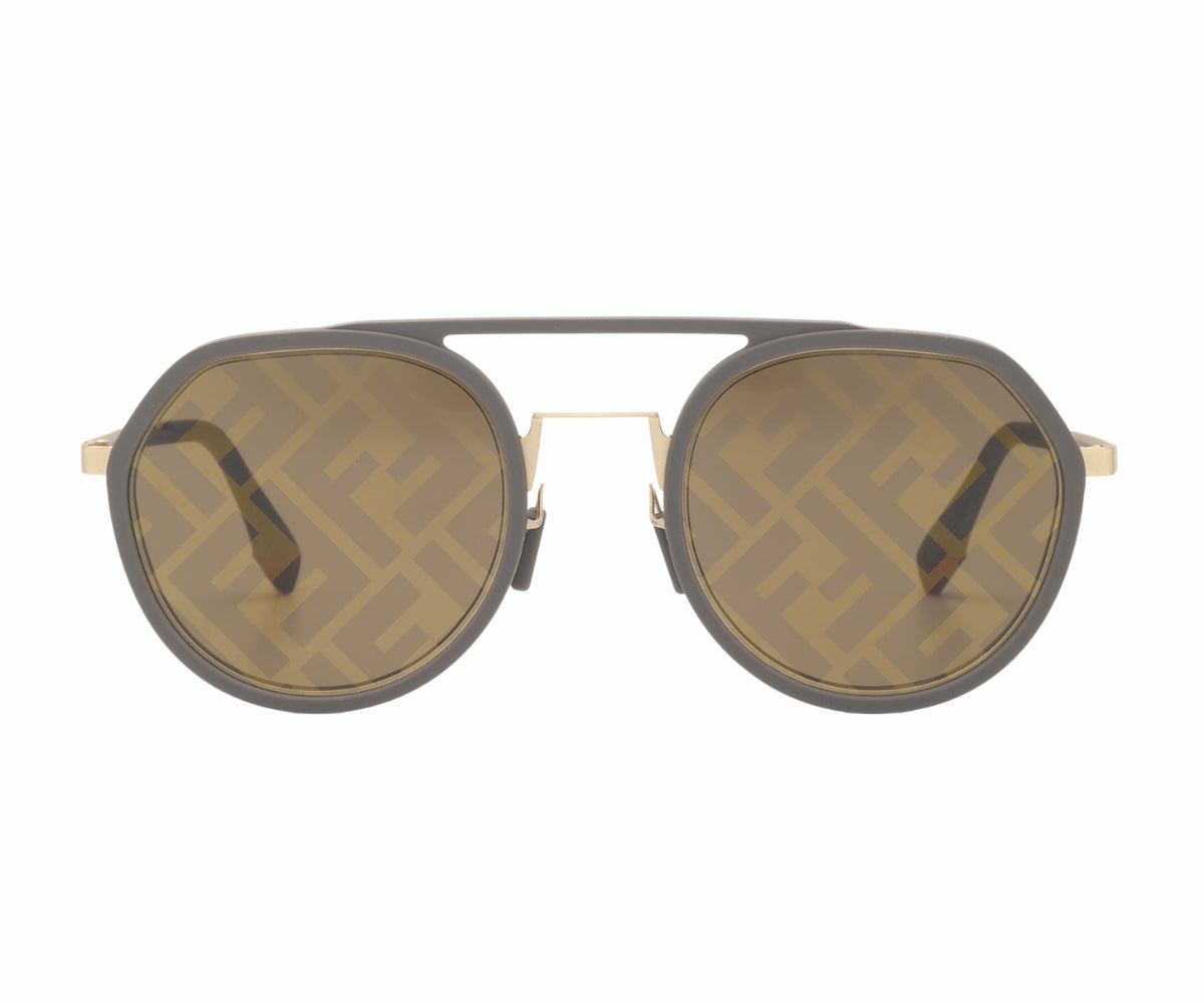 Sunglasses with a gold frame and dark lenses on a white background