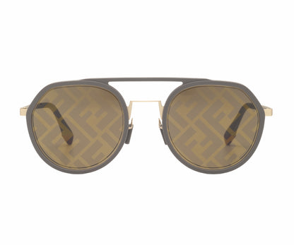 Sunglasses with a gold frame and dark lenses on a white background