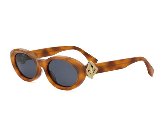 Sunglasses with tortoiseshell frame and dark lenses on a white background