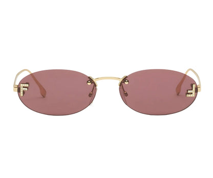 Sunglasses with gold frame and red-tinted lenses on a white background