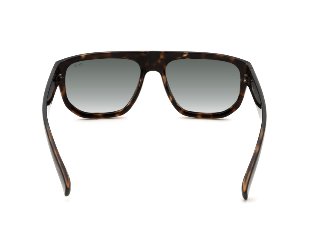 Sunglasses with tortoiseshell frame and dark lenses on a white background