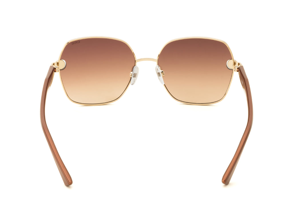 Sunglasses with brown gradient lenses and gold frames on a white background