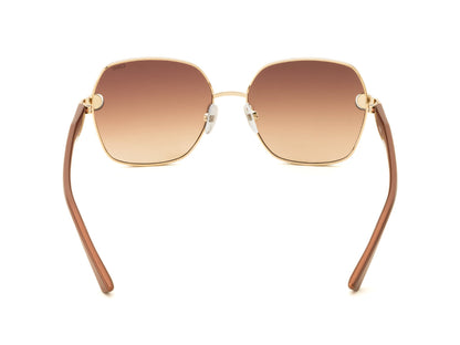Sunglasses with brown gradient lenses and gold frames on a white background