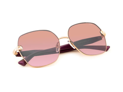 Sunglasses with pink gradient lenses and gold frames on a white background