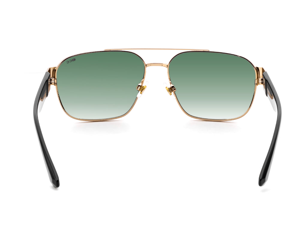 Sunglasses with gold frame and black arms on a white background