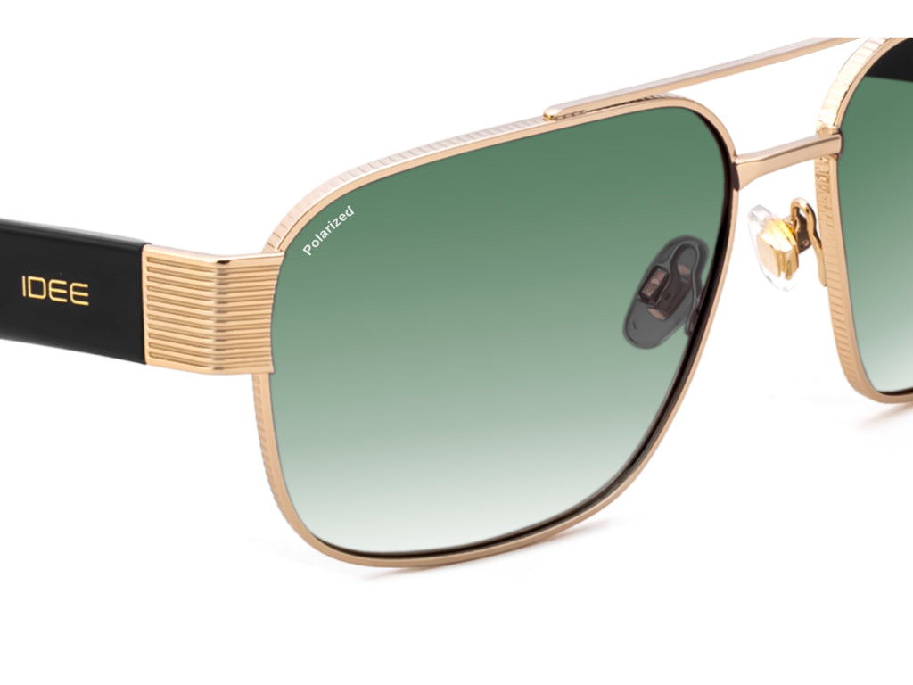 Gold-framed sunglasses with green gradient lenses on a white background