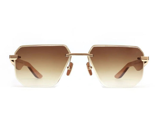 Gold-framed sunglasses with gradient lenses on a white background
