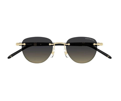 Sunglasses with black gradient lenses and gold frames on a white background