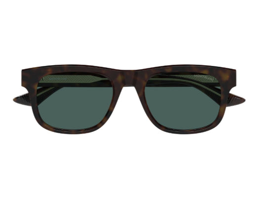 Sunglasses with tortoiseshell frame and dark lenses on a white background