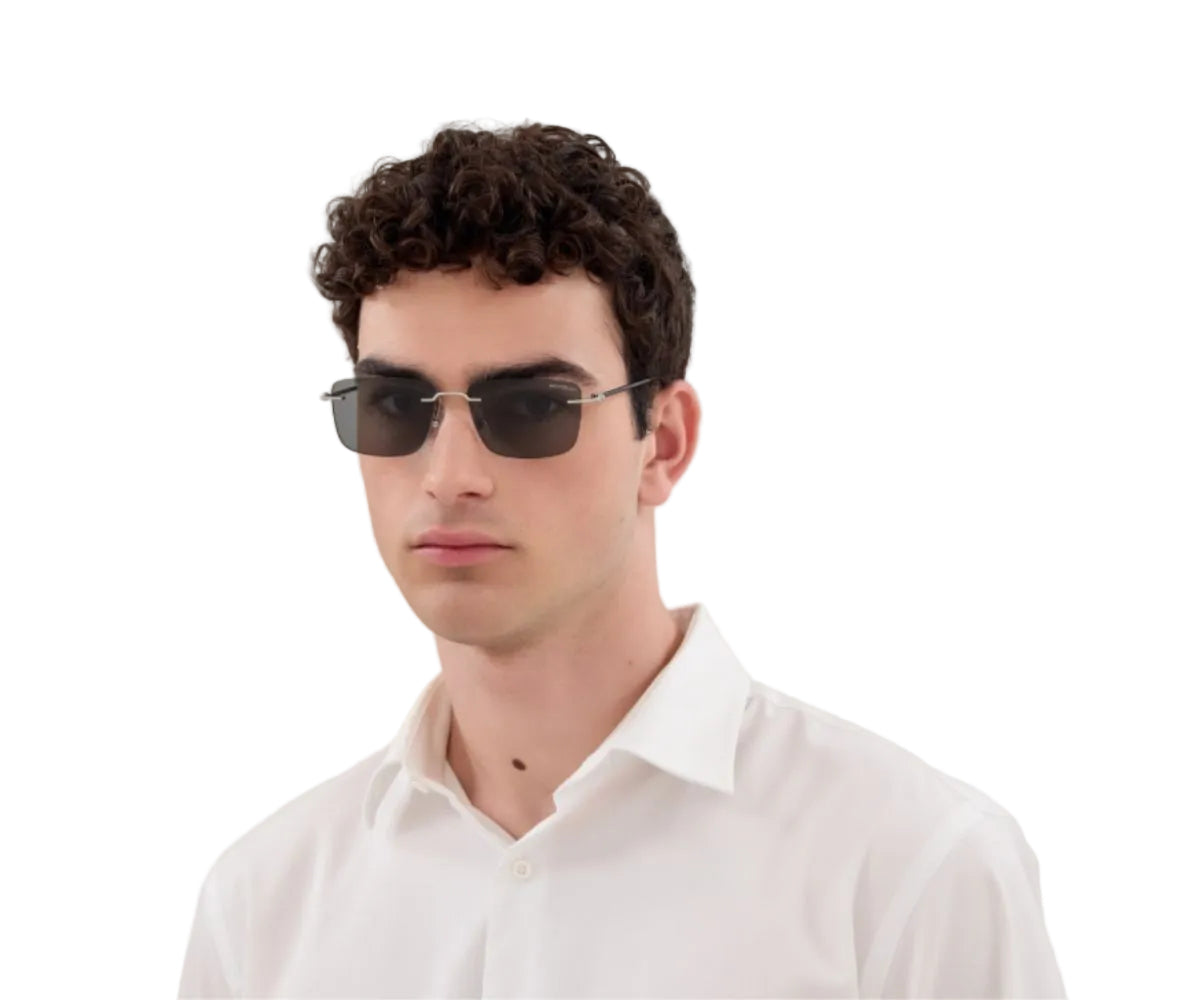 Man wearing dark sunglasses and a white shirt on a white background