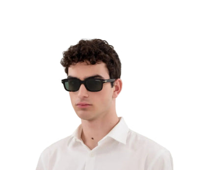 Man wearing black sunglasses and a white shirt on a white background