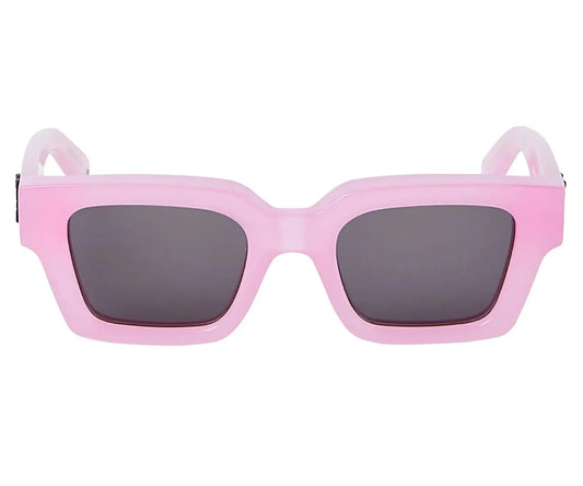 Pink sunglasses with dark lenses on a white background