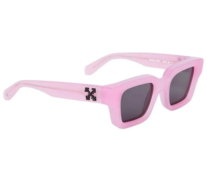 Pink sunglasses with dark lenses on a white background
